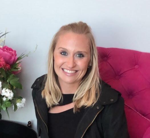 Accounts Manager Allison sitting in a chair in our Portsmouth, NH web design office smiling.