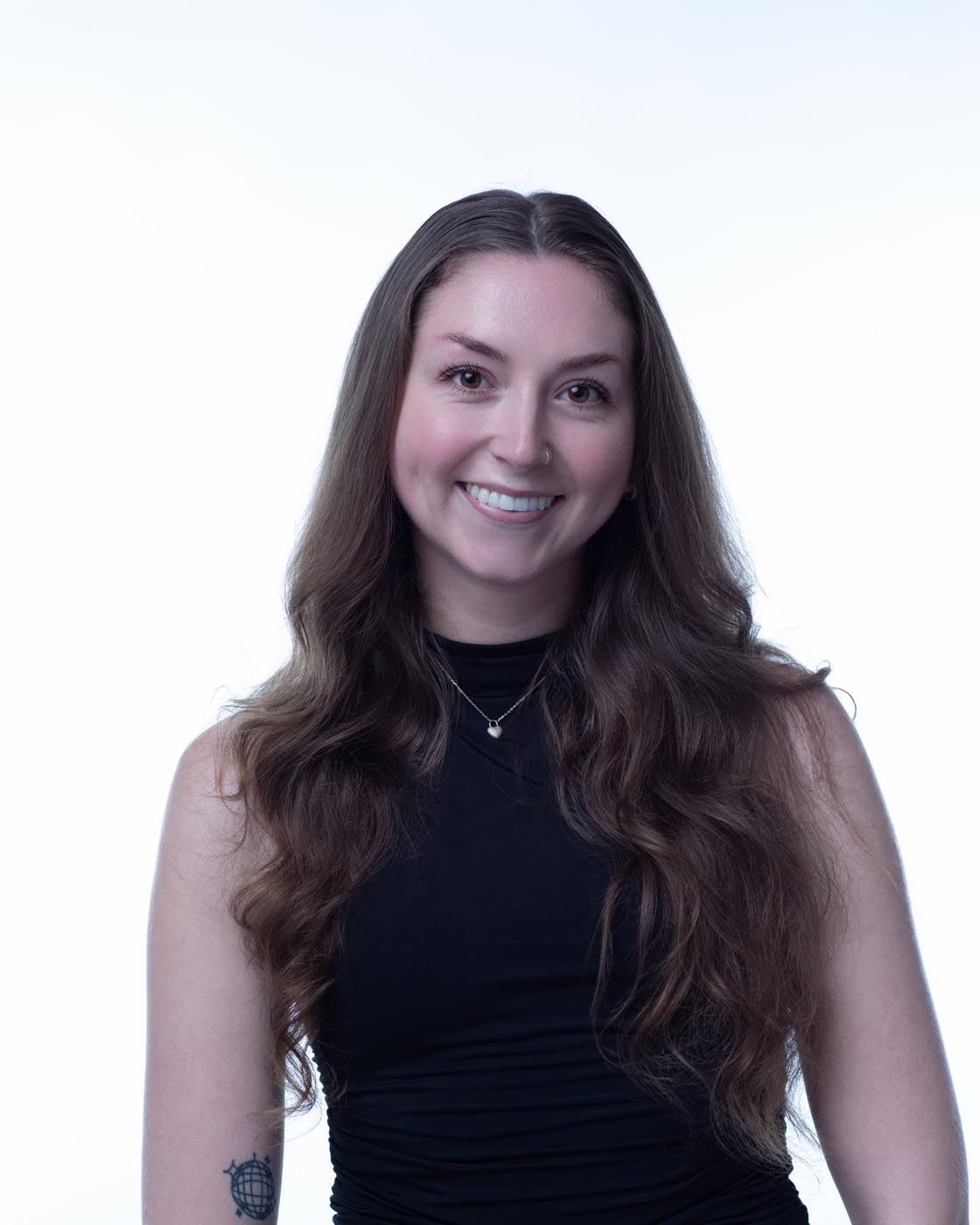 Accounts Manager Allison sitting in a chair in our Portsmouth, NH web design office smiling.