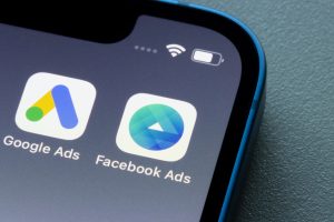 Phone displaying apps for Google Ads and Facebook Ads.