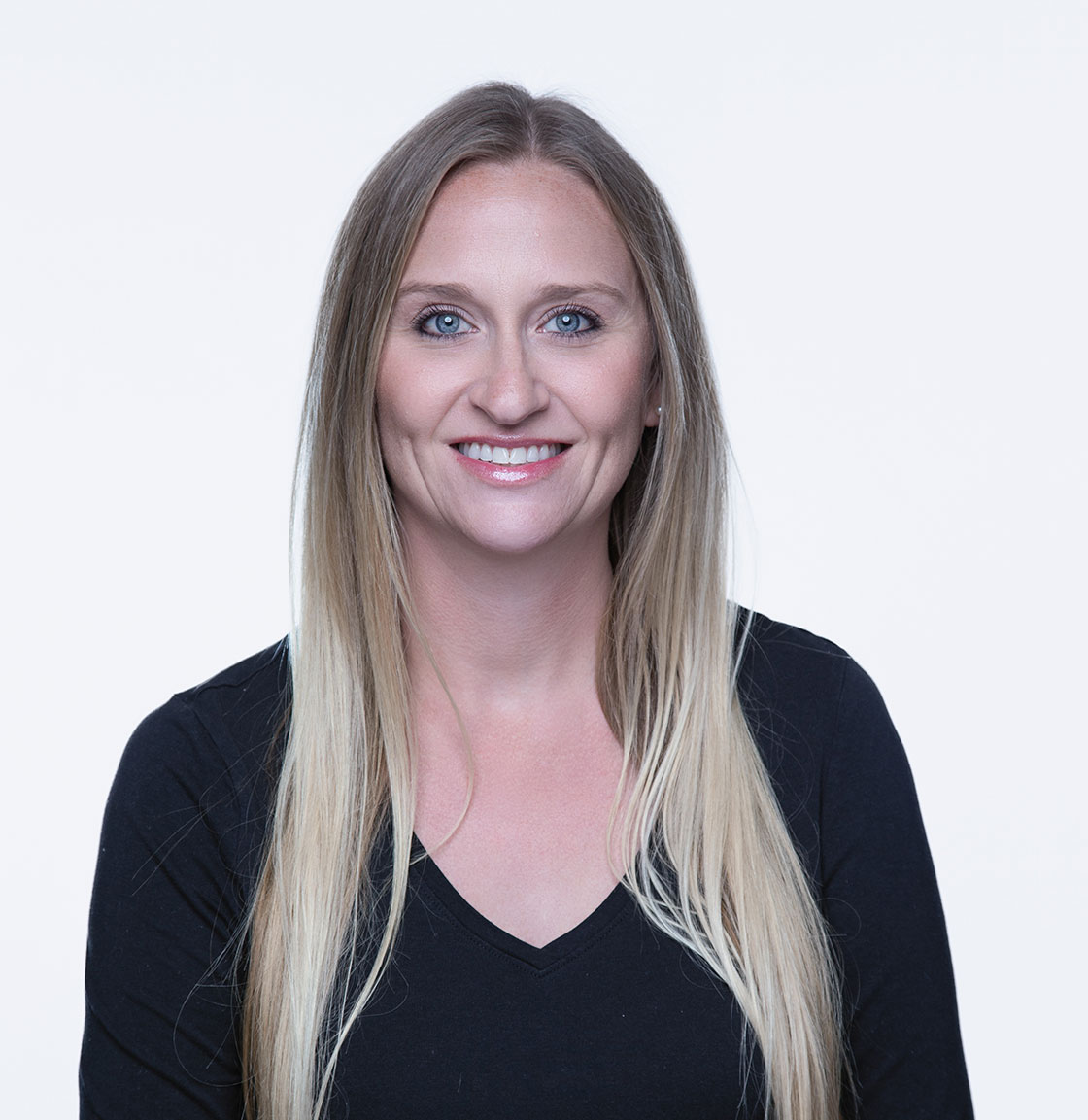 Accounts Manager Allison sitting in a chair in our Portsmouth, NH web design office smiling.